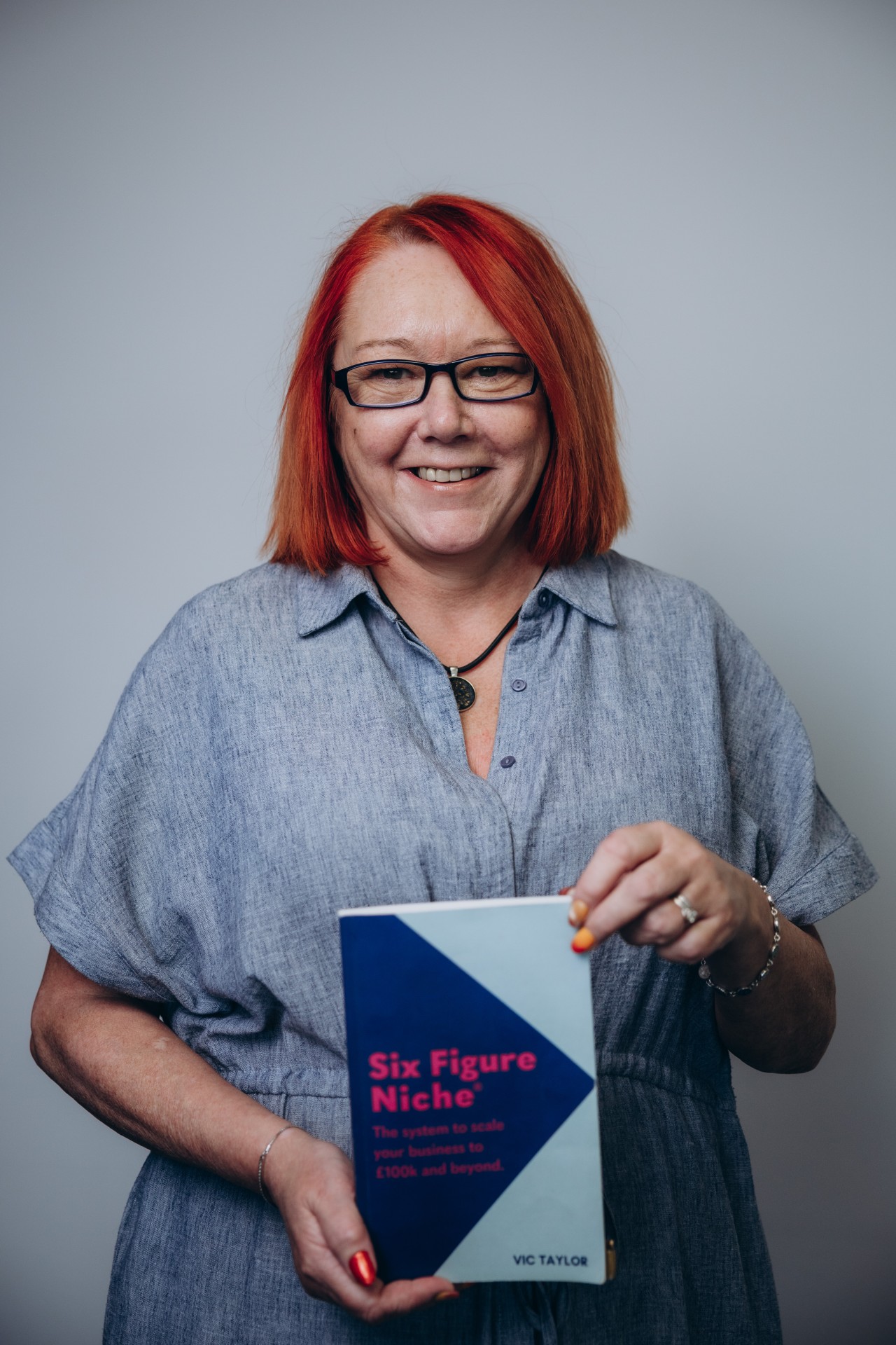 Sue holding the Six Figure Niche Book